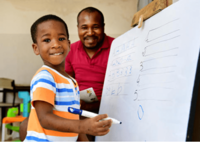 father and son home learning at a whiteboard