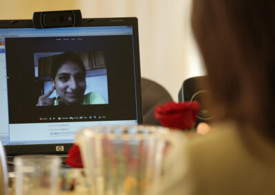 someone looking at a laptop with a video call displayed