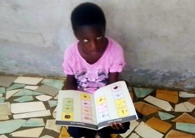 Blind girl in Senegal with books