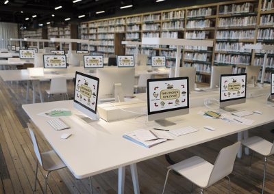 Computer screens as learning stations set up in library setting