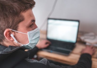 Student wearing a mask with laptop