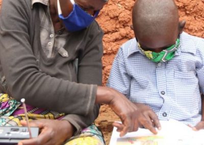 Teacher working with a child - wearing masks