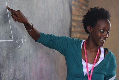 Teacher pointing to chalkboard