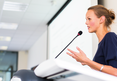 Young woman standing at a lectern