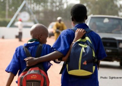 African origin boys with backpacks, arms around each other