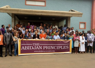 group photo with banner from Abidjan priniciples event