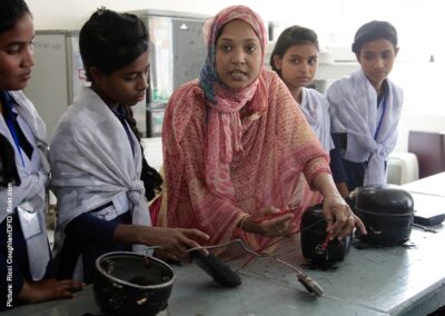 Teacher demonstrating electrical wiring to girl students in Bangladesh