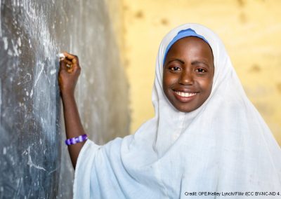 Nigierian school girl in headscarf at blackboard