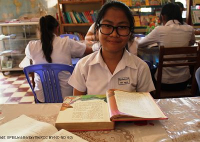 Child at desk with text book