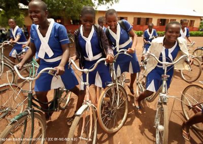 African School girls in uniform on bicyles