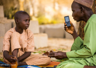 Boy and man with mobile phone listening to a lesson