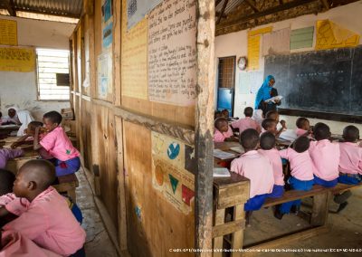 Children in class wearing pink shirts and blue shorts