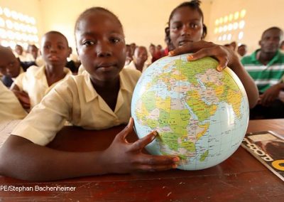 School child in Sierra Leone with globe