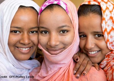 three smiling girls wearing headscarves