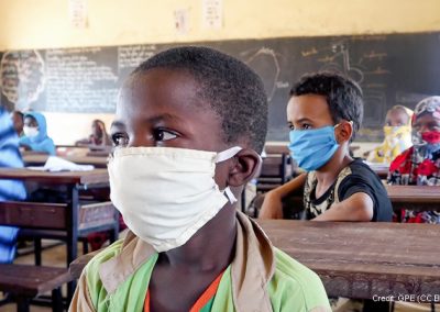 Primary age children in classroom in Niger, wearing masks