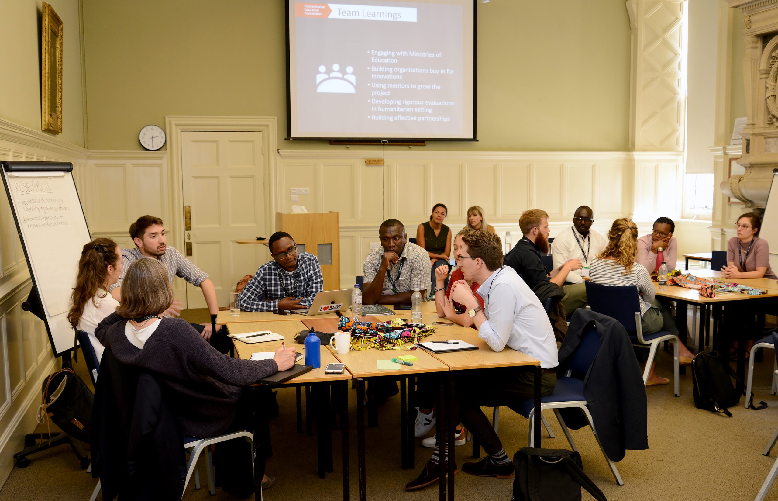 workshop at UKFIET Conference 2019 with groups sitting around tables in discussion.