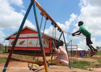 children play in the playground of their pre-school, Uganda.