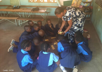 A teacher engages students through play in the classroom in Zambia