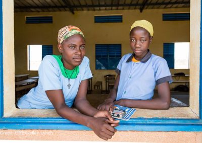 Two teenage girls at their classroom window, Niger.