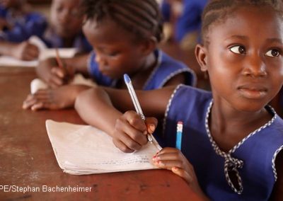 Girl writing in her notebook in class, Sierra Leone