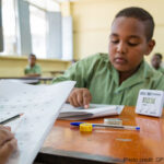 A student identifies letters during a national learning assessment, Sudan.