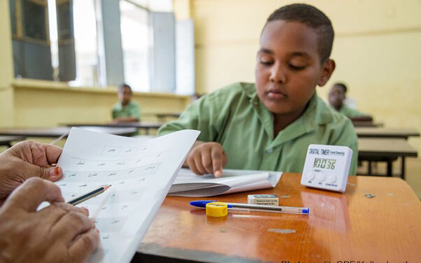 A student identifies letters during a national learning assessment, Sudan.