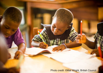 Young children learn writing at their desk in a primary school, Ghana.