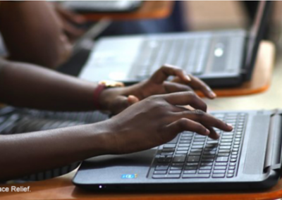 Hands typing on a laptop keyboard