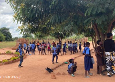 Children playing outside a community school, awaiting the next ‘shift’.