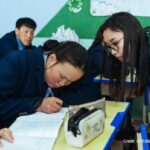 17-year-old deaf student concentrates during a language lesson, Mongolia. Her teacher is watching