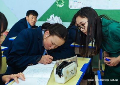 17-year-old deaf student concentrates during a language lesson, Mongolia. Her teacher is watching