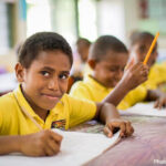 Students wearing yellow shirts in class, Vanuatu