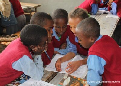 Students wearing blue and red uniform in class 4C at the Hidassie Primary School in Addis Ababa, Ethiopia, do group work during a social science class.