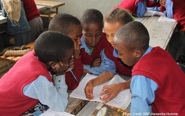 Students wearing blue and red uniform in class 4C at the Hidassie Primary School in Addis Ababa, Ethiopia, do group work during a social science class.