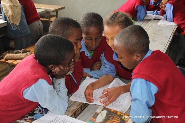 Students wearing blue and red uniform in class 4C at the Hidassie Primary School in Addis Ababa, Ethiopia, do group work during a social science class.