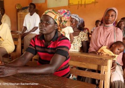 PTA meeting, Asunafo South District, Ghana one woman with child on her knee