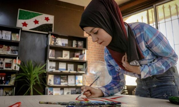 Woman painting on a table in a library, Aleppo