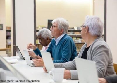 Three older people in a computer class, Portugal.